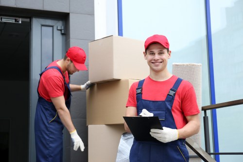 Local movers handling furniture in a Westminster residential street