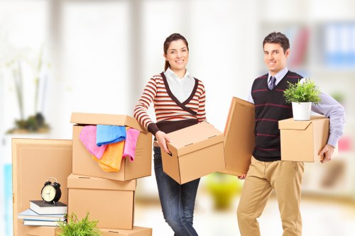 Loading furniture into a moving van in a Westminster residential street