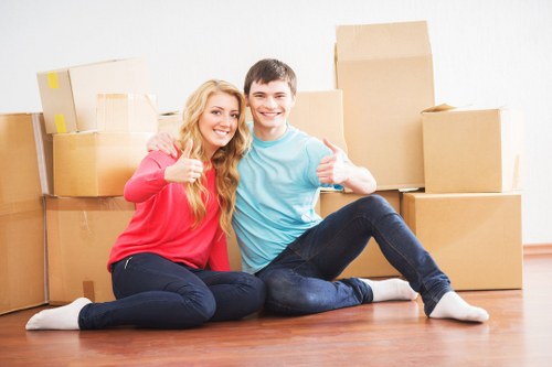 Moving crew handling boxes and furniture for a Westminster home relocation